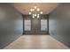 Bright office features hardwood floors, recessed lighting, and a modern chandelier at 2910 Caney Parc Way, Cumming, GA 30041