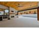 Outdoor kitchen with fireplace, pool view, and wood ceiling at 2910 Caney Parc Way, Cumming, GA 30041