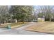 House exterior showcasing a light green ranch home and driveway at 4239 Canby Ln, Decatur, GA 30035