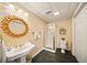 Basement bathroom with a shower, pedestal sink, and gold mirror at 4684 Chardonnay Ct, Atlanta, GA 30338