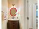 Small powder room with a red framed mirror and pedestal sink at 4684 Chardonnay Ct, Atlanta, GA 30338