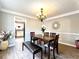 Dining room with hardwood floors, chandelier, and view into the kitchen at 6467 Battery Pt, Stone Mountain, GA 30087