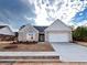 Beautifully new constructed one-story home with brick and siding, an arched window, and attached two-car garage at 853 Crossroads Ct, Social Circle, GA 30025