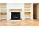 Living room fireplace with built-in shelving on either side at 1011 Dunbar Dr, Atlanta, GA 30338