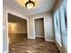 Hardwood floor hallway with access to living room and sunroom at 1011 Dunbar Dr, Atlanta, GA 30338