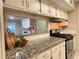 Modern kitchen with granite counters and white cabinets at 1011 Dunbar Dr, Atlanta, GA 30338