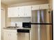 Kitchen with granite countertops, stainless steel appliances, and white cabinets at 1011 Dunbar Dr, Atlanta, GA 30338