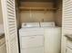 Laundry closet with washer, dryer, and shelving at 1011 Dunbar Dr, Atlanta, GA 30338