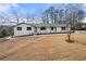 Front exterior view featuring a lawn, a white brick house and large windows at 1412 Dallas Sw Cir, Marietta, GA 30064