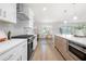 Bright, modern kitchen with stainless steel appliances, white cabinets, and hardwood floors at 1412 Dallas Sw Cir, Marietta, GA 30064