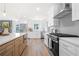 Modern kitchen with stainless steel appliances, white cabinetry, and island at 1412 Dallas Sw Cir, Marietta, GA 30064