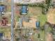 Birds-eye view displaying a single-story home, large backyard with outbuildings, and neighborhood streets at 1626 Rice Rd, Lithonia, GA 30058