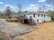 Exterior view of a home with a wood deck and stairs, a yard, and a concrete driveway at 1626 Rice Rd, Lithonia, GA 30058