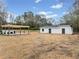 View of the backyard with an outdoor kitchen area and a single-story building at 1626 Rice Rd, Lithonia, GA 30058