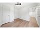 Well-lit bedroom featuring hardwood floors, a ceiling fan with a light, and a closet at 1626 Rice Rd, Lithonia, GA 30058