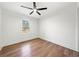 Minimalist bedroom with wood floors, ceiling fan, and natural light from a window at 1626 Rice Rd, Lithonia, GA 30058