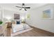 Well-lit bedroom with wood floors, ceiling fan, stylish furnishings, and a serene atmosphere at 1626 Rice Rd, Lithonia, GA 30058