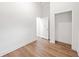 Bright bedroom featuring hardwood floors, a closet, and doorway leading to an adjacent room at 1626 Rice Rd, Lithonia, GA 30058