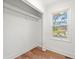 Bright closet featuring a wood floor, closet rod and shelving, and a window for natural light at 1626 Rice Rd, Lithonia, GA 30058