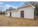 Side exterior view of a white building with two doors, situated on a grassy lot at 1626 Rice Rd, Lithonia, GA 30058