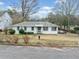 Charming single-story home featuring a classic white exterior and a well-maintained front yard at 1626 Rice Rd, Lithonia, GA 30058