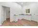 Kitchenette with white cabinets, countertops, stainless sink, and a view through the window at 1626 Rice Rd, Lithonia, GA 30058