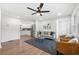 Bright living room with hardwood floors, contemporary decor, and stainless steel appliances in the kitchen at 1626 Rice Rd, Lithonia, GA 30058