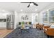 Stylish living room with hardwood floors, grey couch, leather chairs, and large windows for natural light at 1626 Rice Rd, Lithonia, GA 30058