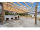 Spacious outdoor kitchen featuring a concrete counter and wooden pergola frame at 1626 Rice Rd, Lithonia, GA 30058