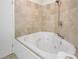 Relaxing bathroom with corner jetted tub and tile surround at 4870 Twin Lakes Trl, Atlanta, GA 30360