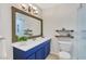 Updated bathroom with blue vanity, large mirror, and walk-in shower at 4870 Twin Lakes Trl, Atlanta, GA 30360