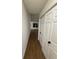 Long hallway with vinyl flooring and white doors at 11110 Mortons Xing, Alpharetta, GA 30022