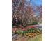 Landscaped view with flowering trees, vibrant tulips, and winding road, surrounded by buildings at 1507 Wynnes Ridge Se Cir, Marietta, GA 30067