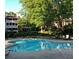 Community pool surrounded by lush greenery and multi-story buildings at 1507 Wynnes Ridge Se Cir, Marietta, GA 30067