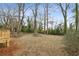 Large backyard with mature trees and a fire pit area at 1682 Valencia Rd, Decatur, GA 30032