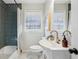 Updated bathroom with modern vanity,hexagon tile flooring and dark green tile shower at 1682 Valencia Rd, Decatur, GA 30032