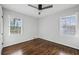 Spacious bedroom with hardwood floors and two windows at 1682 Valencia Rd, Decatur, GA 30032