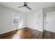 Well-lit bedroom with hardwood floors and a ceiling fan at 1682 Valencia Rd, Decatur, GA 30032