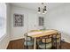 Light and airy dining room with a wood table, green chairs, and modern light fixture at 1682 Valencia Rd, Decatur, GA 30032