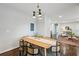 Modern dining room features a wood table and chairs, with an open view to living room at 1682 Valencia Rd, Decatur, GA 30032