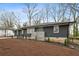 Ranch home features gray brick, updated landscaping, and a modern front door at 1682 Valencia Rd, Decatur, GA 30032