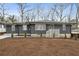 Newly renovated ranch home with gray brick exterior and modern landscaping at 1682 Valencia Rd, Decatur, GA 30032