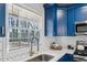 Kitchen sink and counter with white quartz countertops and blue cabinets at 1682 Valencia Rd, Decatur, GA 30032