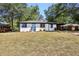 Newly renovated ranch home with a light blue front door, freshly painted exterior and landscaping at 1709 Valencia Rd, Decatur, GA 30032