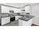 Modern kitchen with white cabinets, granite countertops, and stainless steel appliances at 1709 Valencia Rd, Decatur, GA 30032