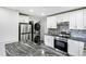 Modern kitchen with stainless steel appliances and granite countertops at 1709 Valencia Rd, Decatur, GA 30032