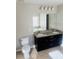 Bathroom with double sink vanity, granite countertop, dark cabinetry, and large mirror at 1963 White Top Rd., Lawrenceville, GA 30045