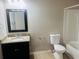 Bathroom with a single sink vanity, framed mirror, toilet, and bath and shower combo at 1963 White Top Rd. Se, Lawrenceville, GA 30045