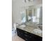 Spacious bathroom featuring a double sink vanity with granite countertop, tub, and separate shower at 1963 White Top Rd., Lawrenceville, GA 30045