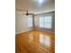 Bedroom with hardwood flooring, a ceiling fan, and a large window with blinds at 1963 White Top Rd., Lawrenceville, GA 30045